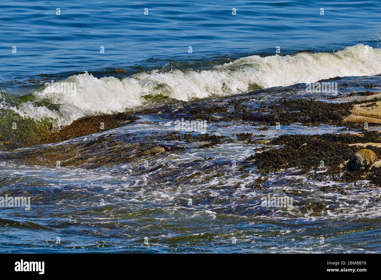 An ocean breaking over a rocky shore on Vancouver Island British Columbia Canada Stock Photo