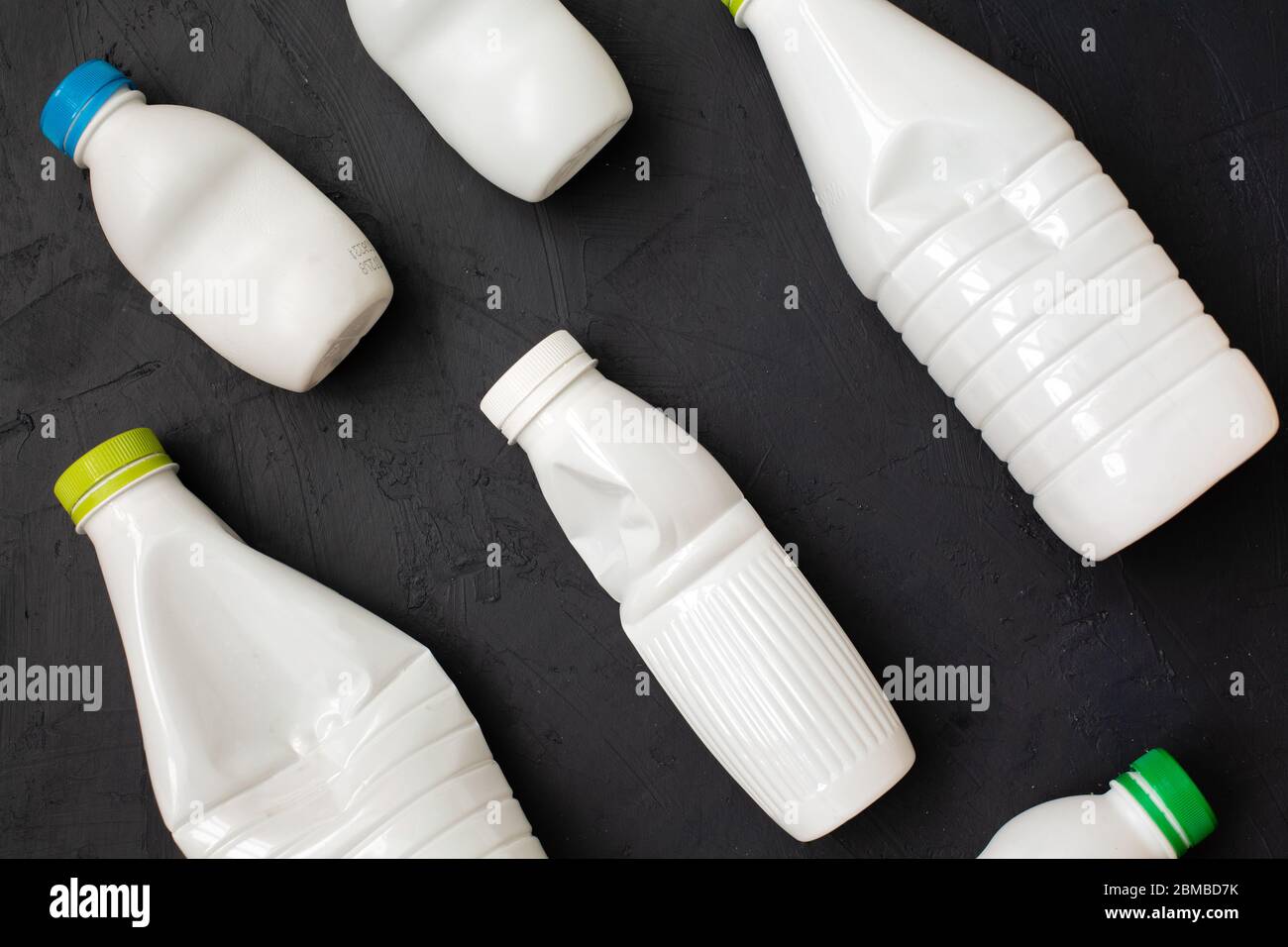 https://c8.alamy.com/comp/2BMBD7K/crushed-plastic-bottles-heap-ready-for-recycling-on-black-background-recycle-plastic-waste-pollution-concept-copy-space-top-view-2BMBD7K.jpg