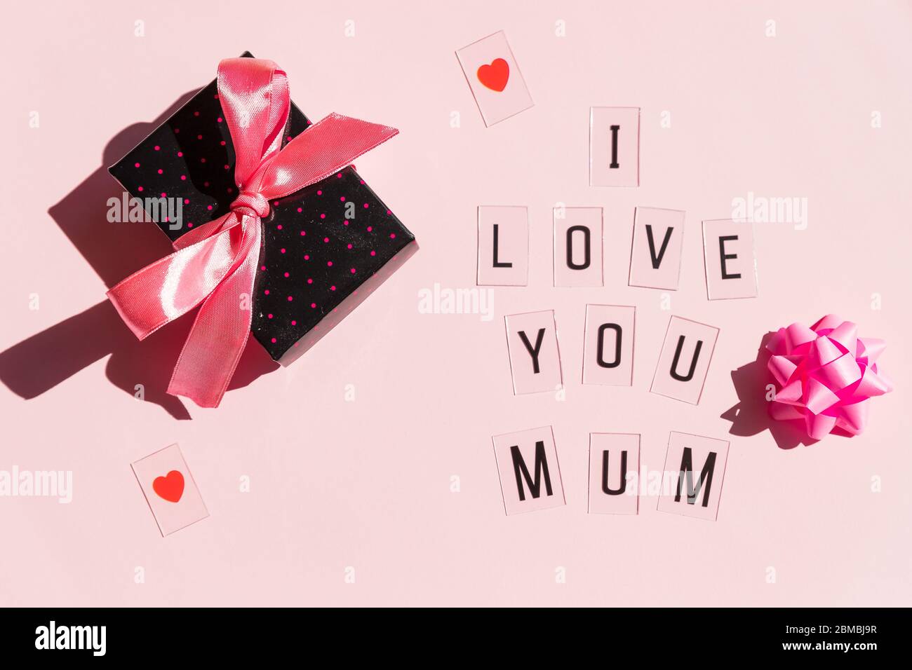 Happy Mothers Day message with red hearts on bright pink background ...