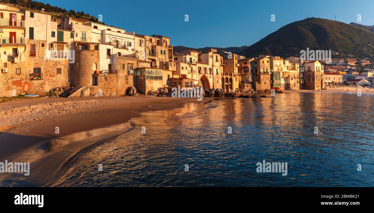 Beautiful panorama of the beach and old town of coastal city Cefalu at sunset, Sicily, Italy Stock Photo