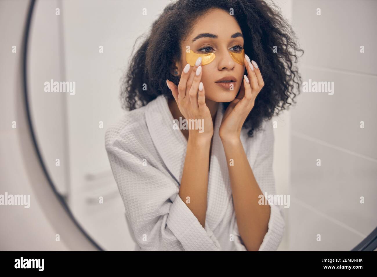 Focused pretty girl performing a beauty procedure Stock Photo