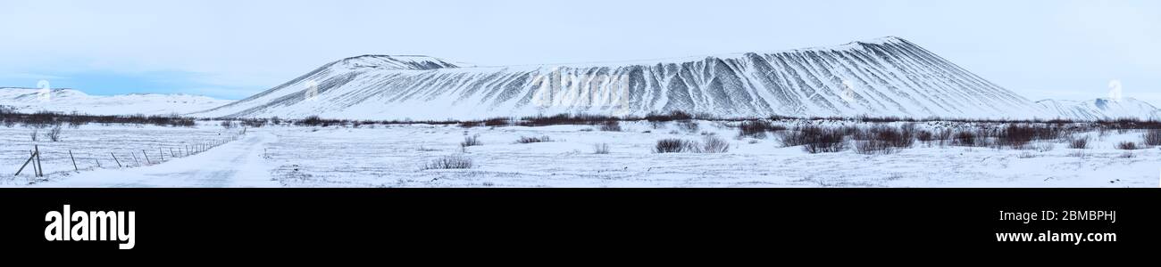 Panorama of Hverfjall, a tephra cone or tuff ring volcano in northern Iceland, to the east of Lake Mývatn, covered in snow in winter. It is one kilome Stock Photo