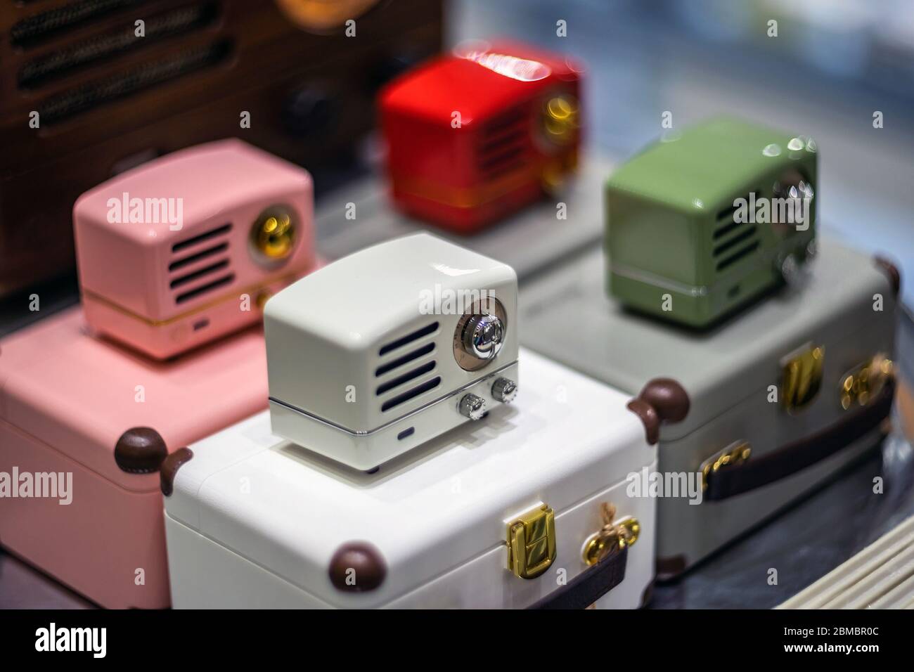 SHANGHAI, CHINA - NOVEMBER 28, 2018. Retro film photo with blurred background. Vintage style small radio are in a gift shop. Modern speakers stylized Stock Photo