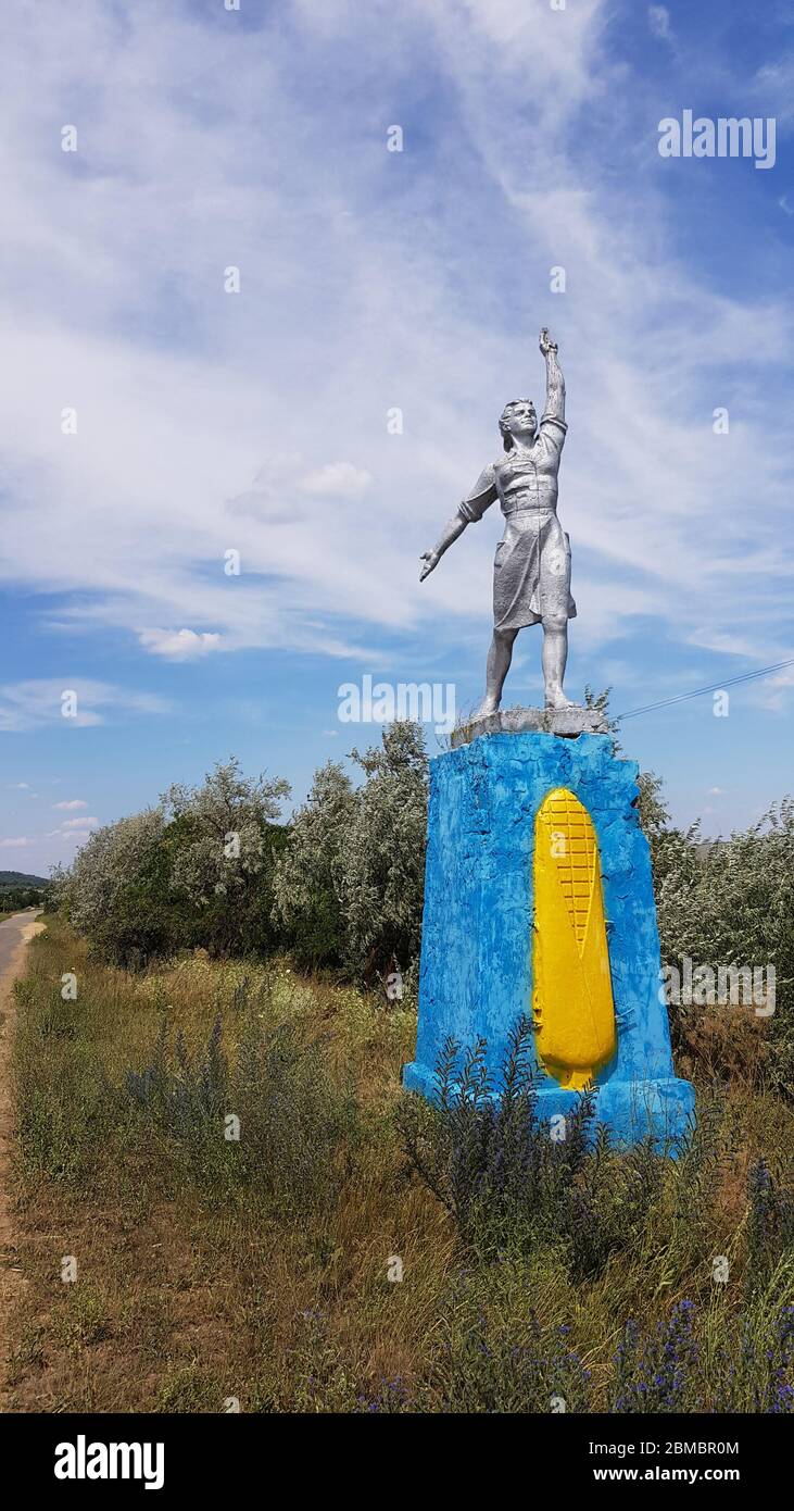 Social realism monument in Odessa countryside of Ukraine. Monumental sculpture of Social-Realism with clouds background Stock Photo