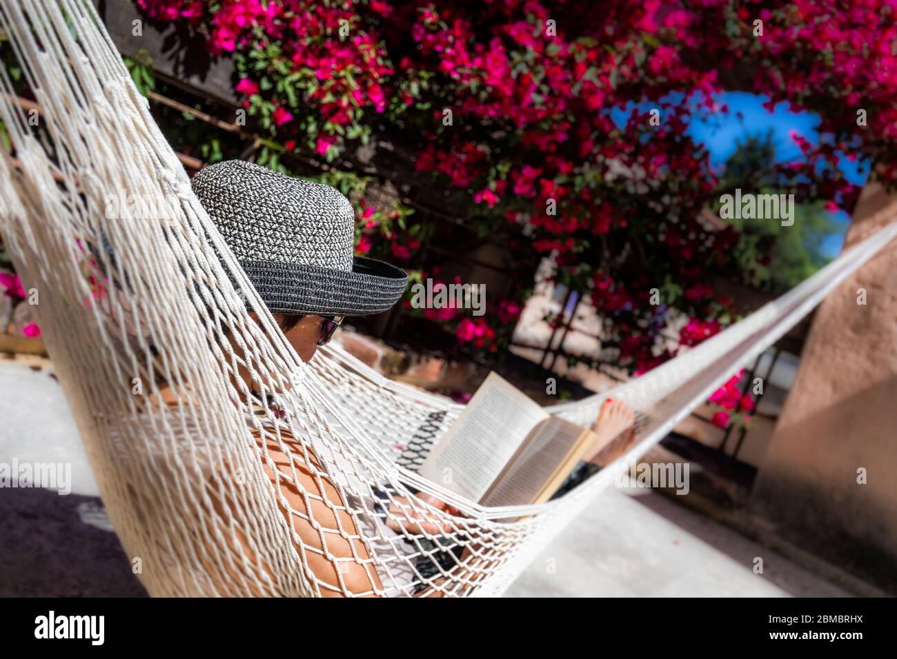 A woman relaxes outside her room in Hacienda Sepulveda, Lagos de Moreno, Jalisco, Mexico. Stock Photo