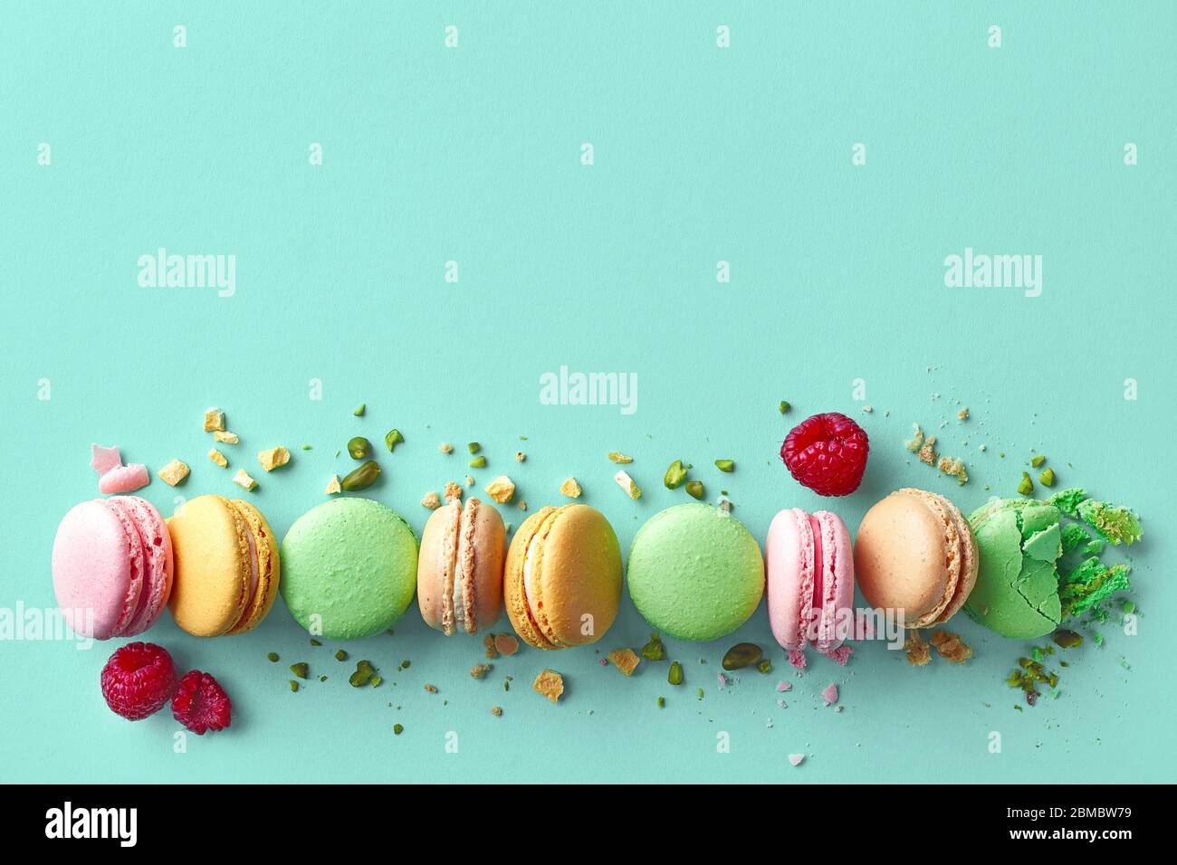 Row of colorful french macarons on blue background. Top view. Pastel ...