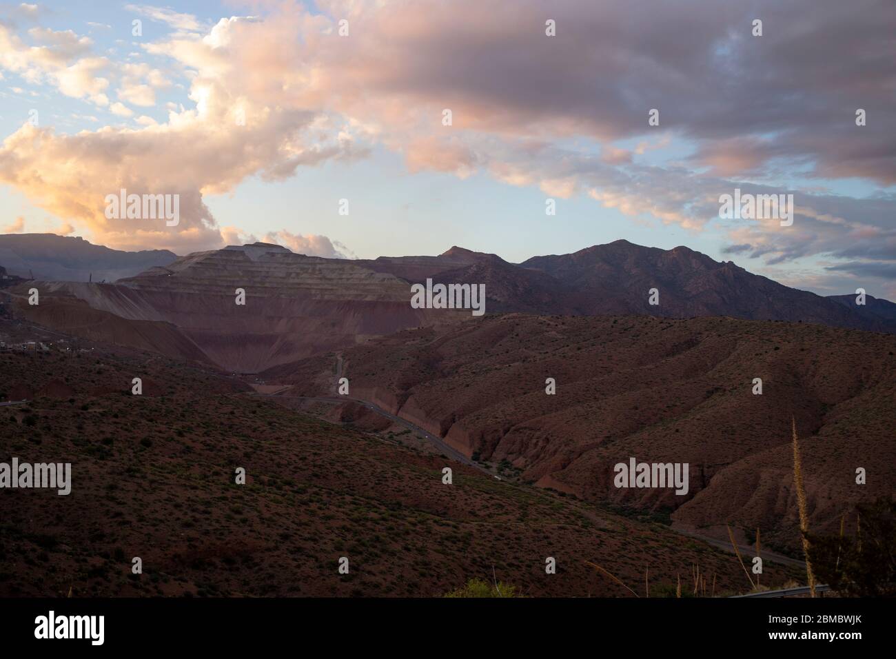 Sunset on mountainous mining landscape colorful clouds in Arizona Stock Photo