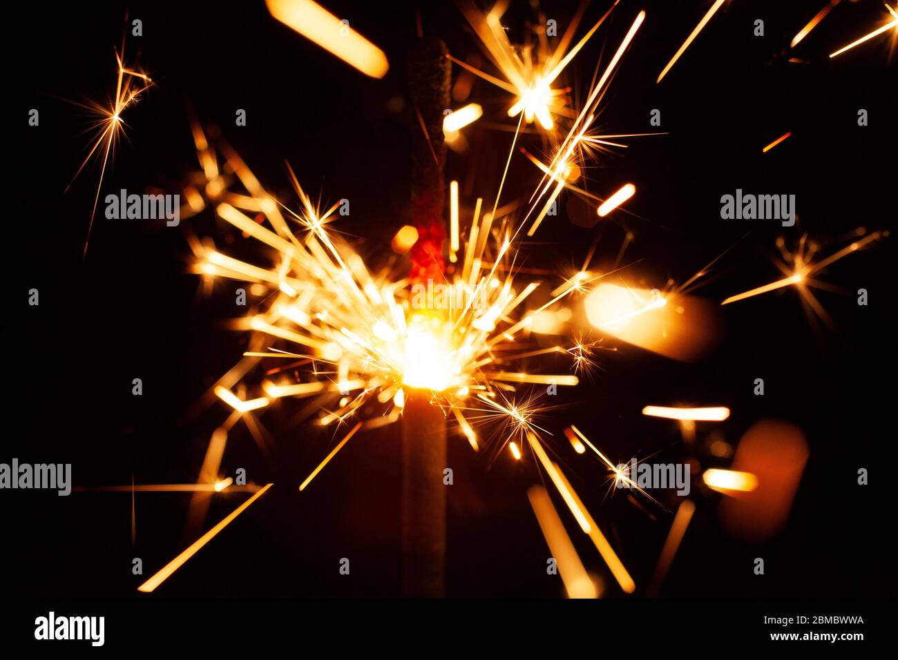 close up on sparkler throwing off fire and sparks Stock Photo Alamy