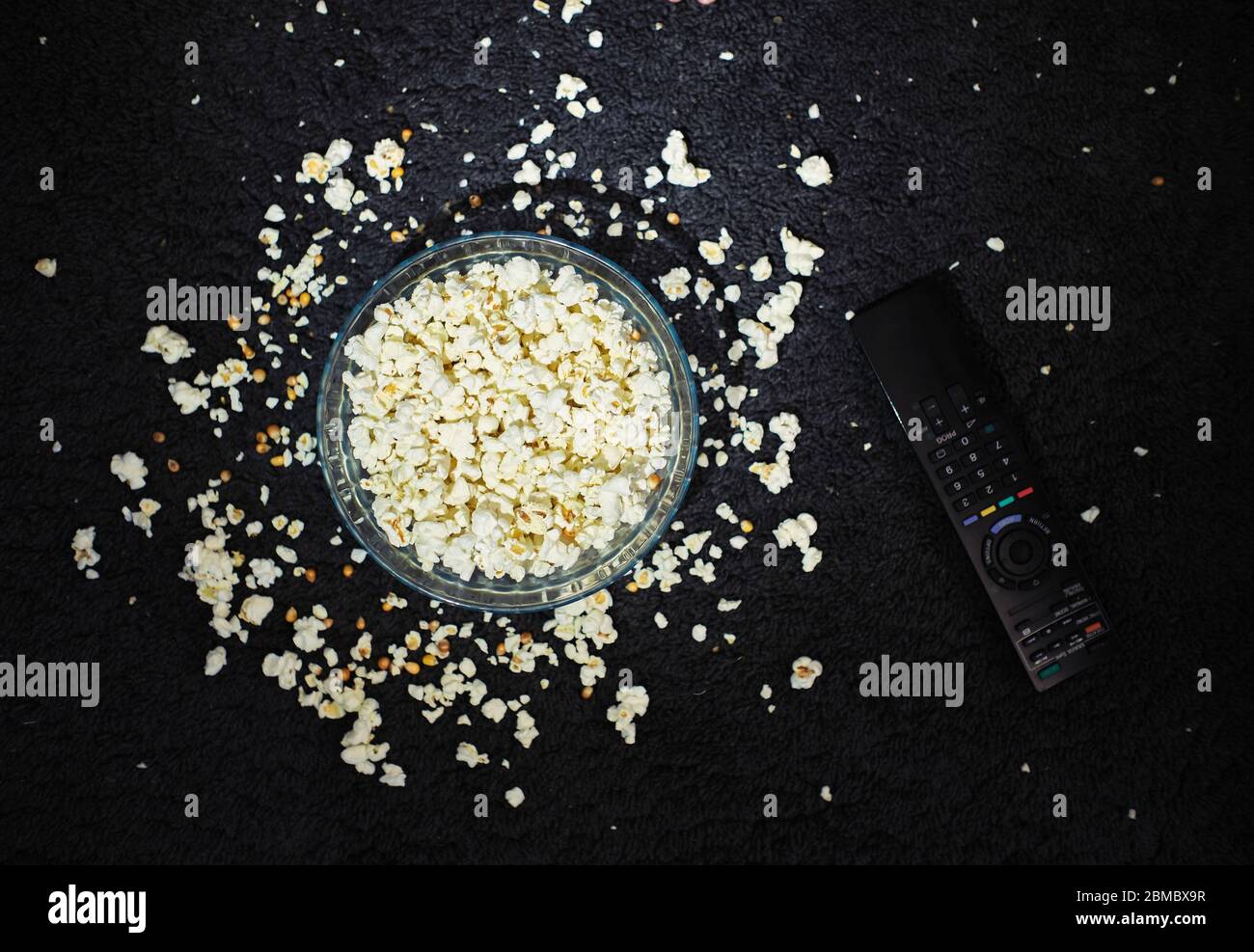 a bowl of popcorn on the floor Stock Photo Alamy