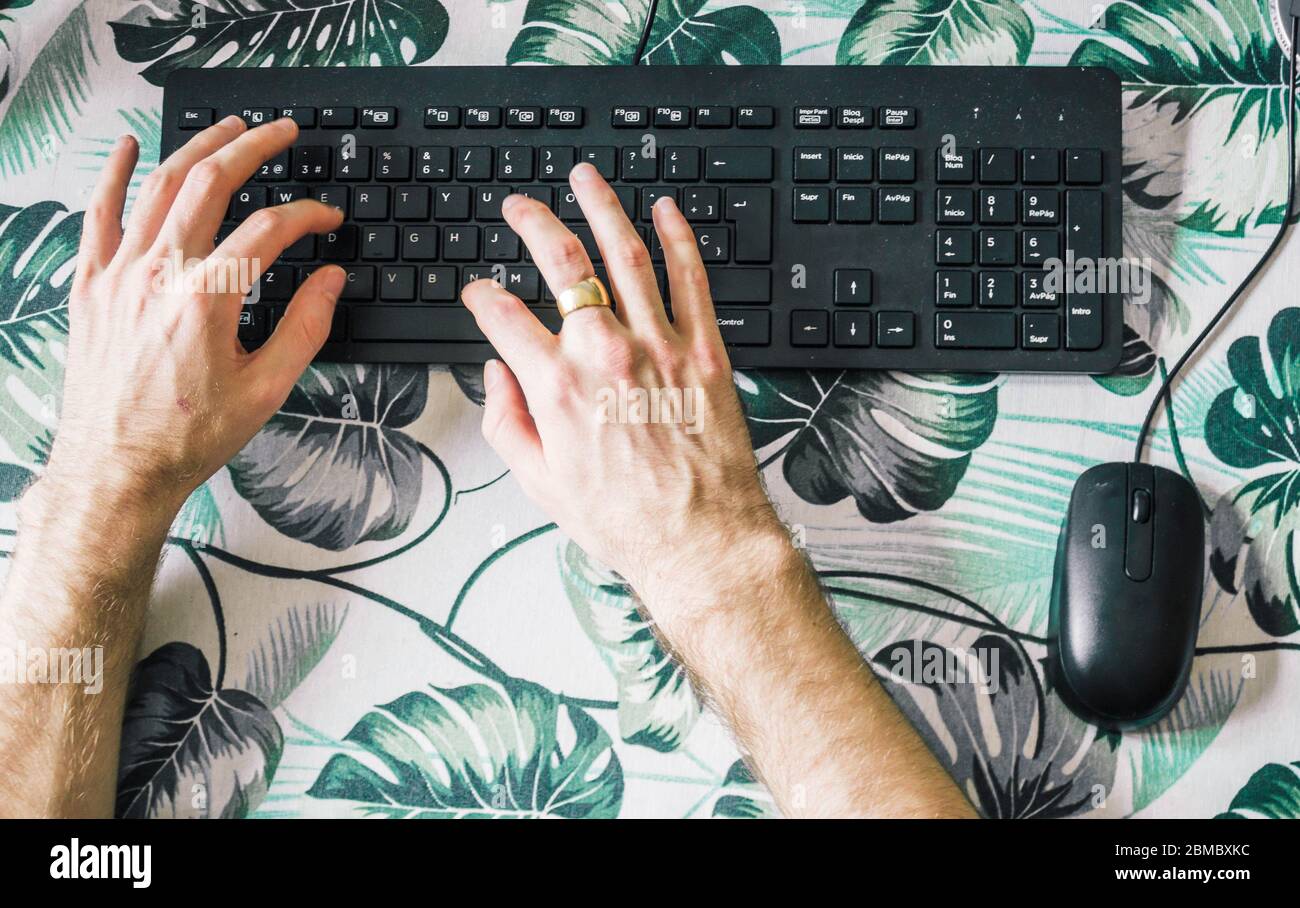 male hands typing on computer keyboard, top view Stock Photo