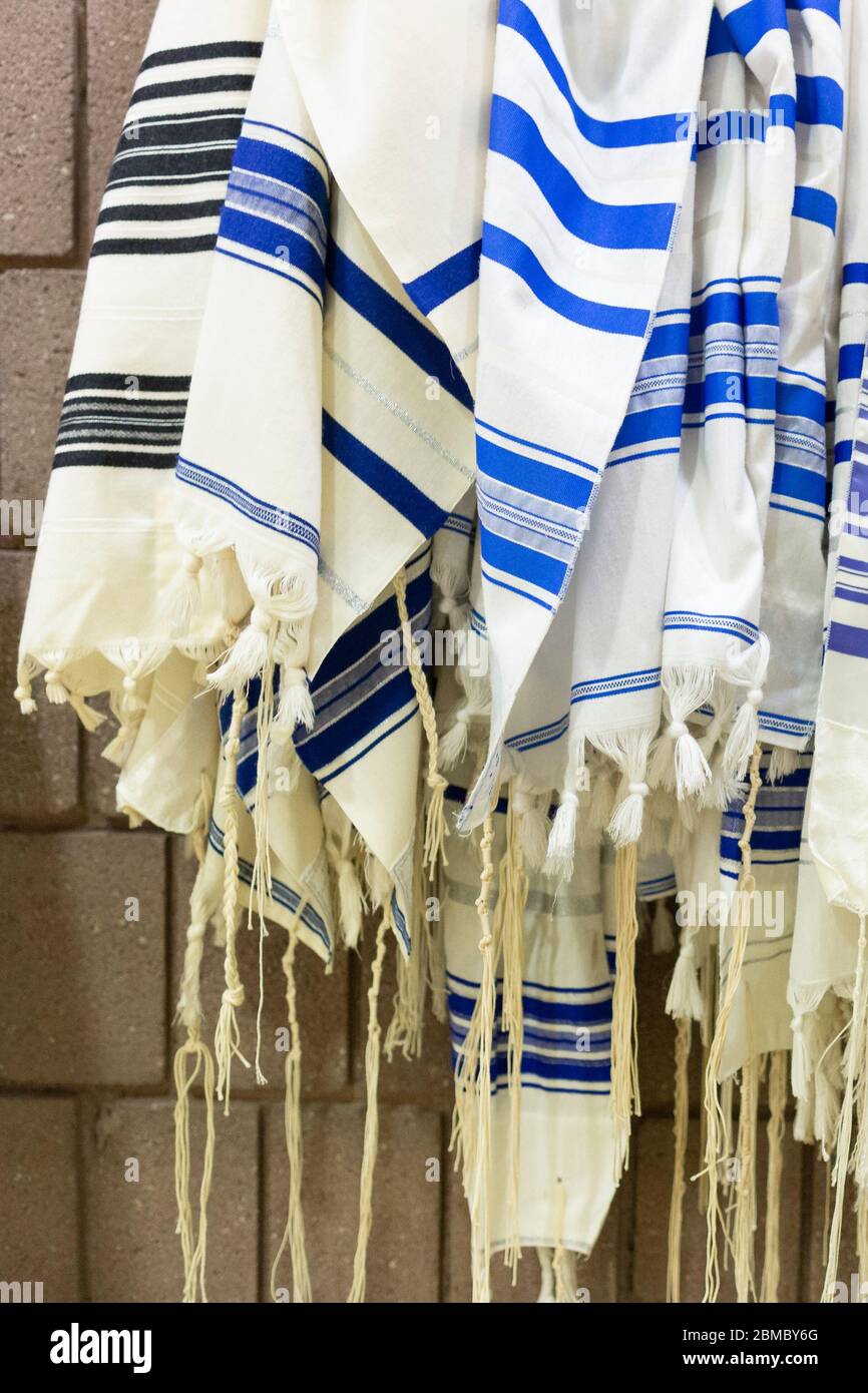 Vertical Image of Many Prayer Shawls Hanging in Jewish Synagogue Stock Photo