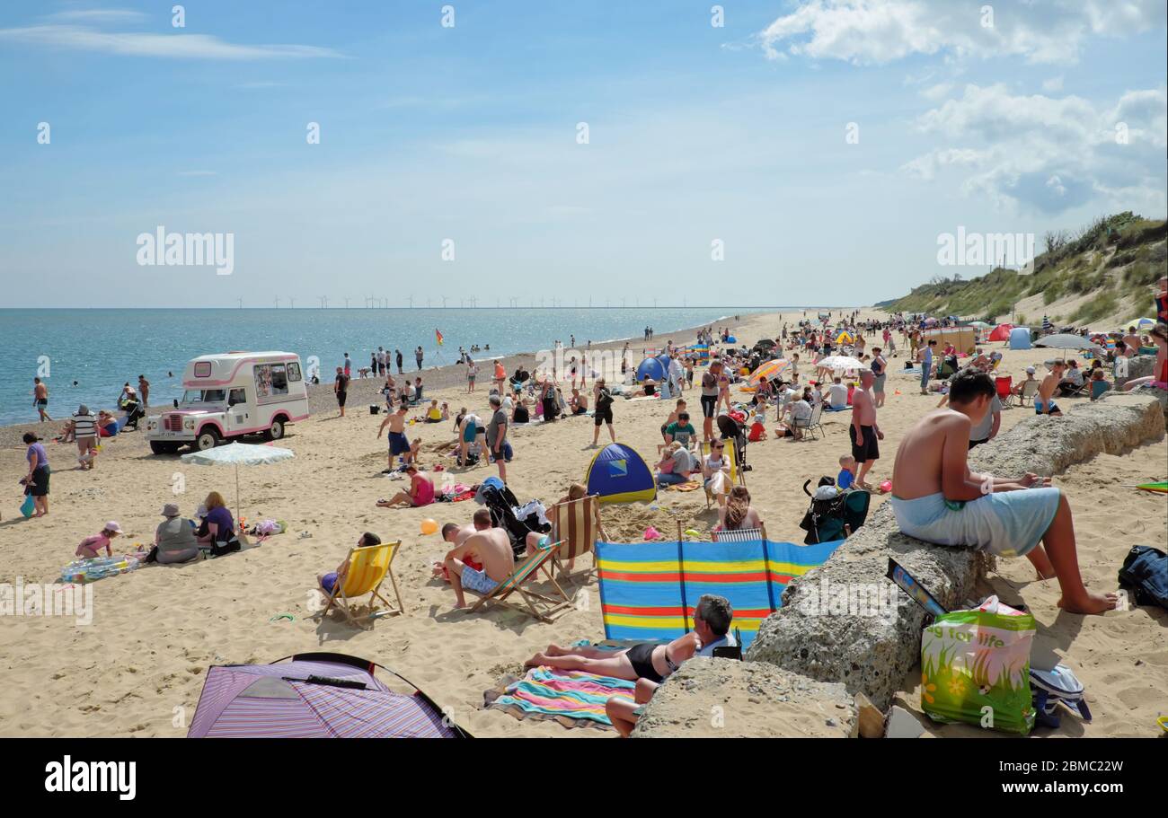 Holidaymakers enjoying a day on Hemsby beach.  Hemsby, Great Yarmouth NR12 9BX Stock Photo