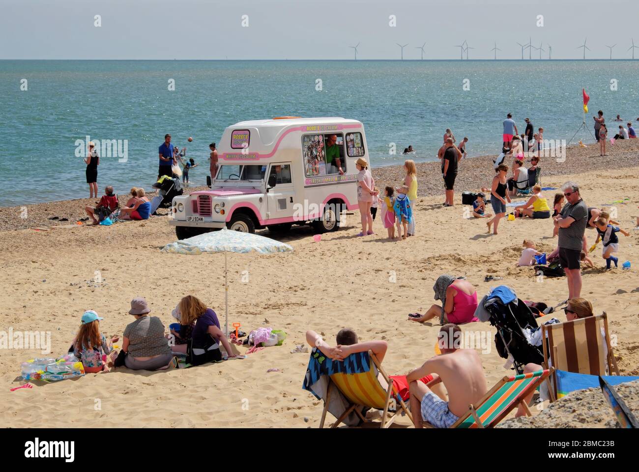 Holidaymakers enjoying a day on Hemsby beach.  Hemsby, Great Yarmouth NR12 9BX Stock Photo