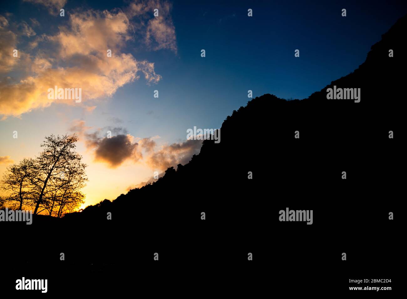 Silhouette of hills and trees at sunset Stock Photo - Alamy