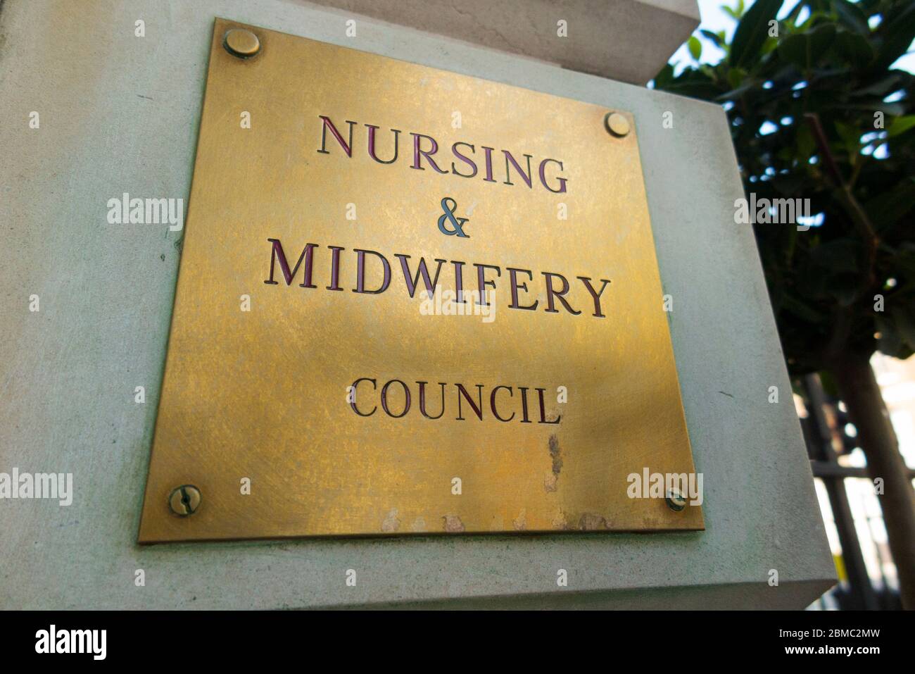 OLD defunct historic and superseded logo on brass name plate / plaque outside the offices of The