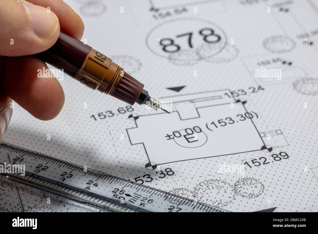 Men holding a pen for pointing the architectural plan Stock Photo