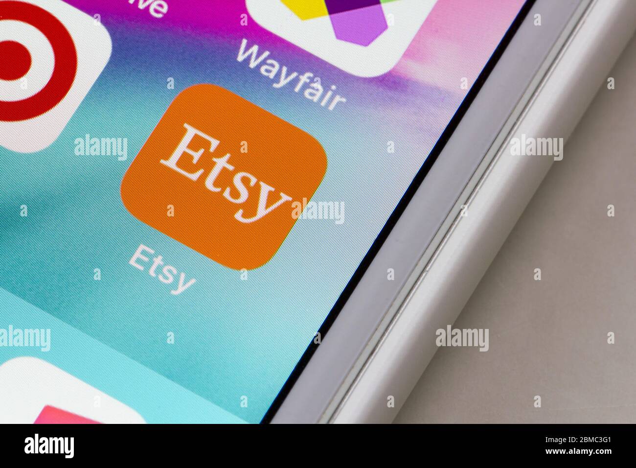 Etsy mobile app icon is seen on an iPhone. Etsy is an American e-commerce website focused on handmade or vintage items and craft supplies. Stock Photo