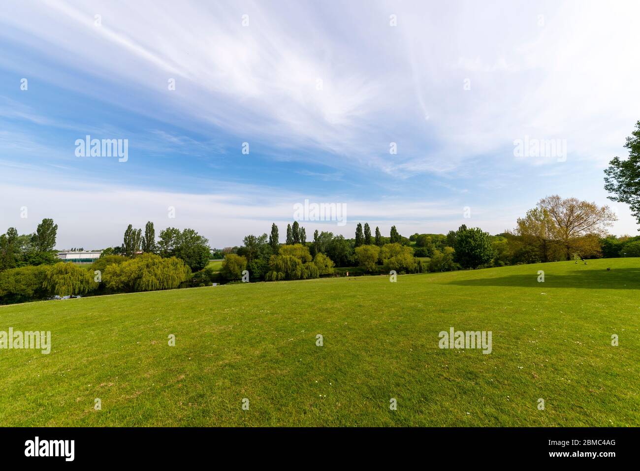 Gloucester Park, Basildon, Essex, UK. Large green space park with lakes. Sunny spring day. Urban neighbourhood park named after the Duke of Gloucester Stock Photo