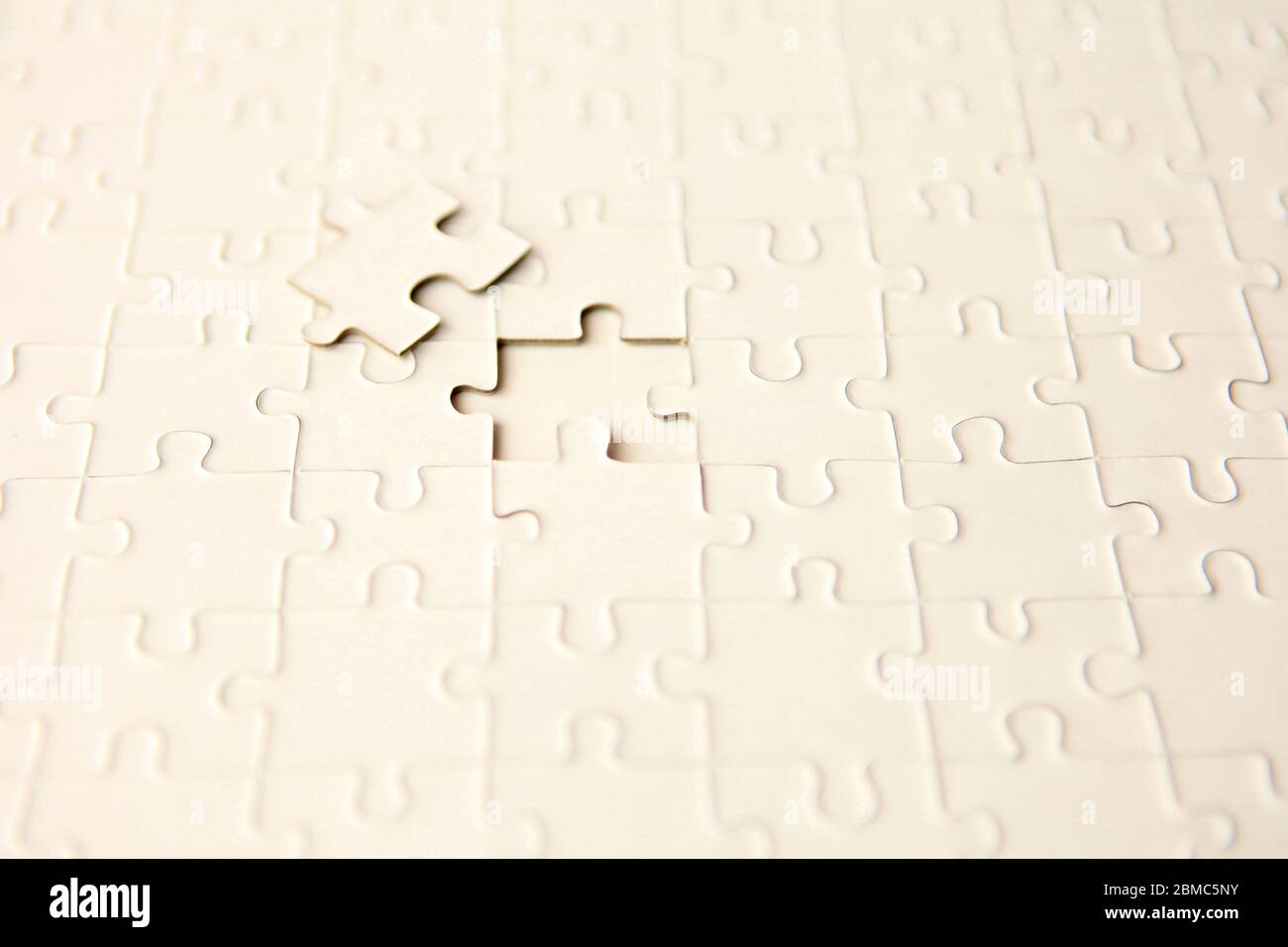 puzzle with missing piece - solution concept. plan white puzzle surface texture with copy space. Stock Photo