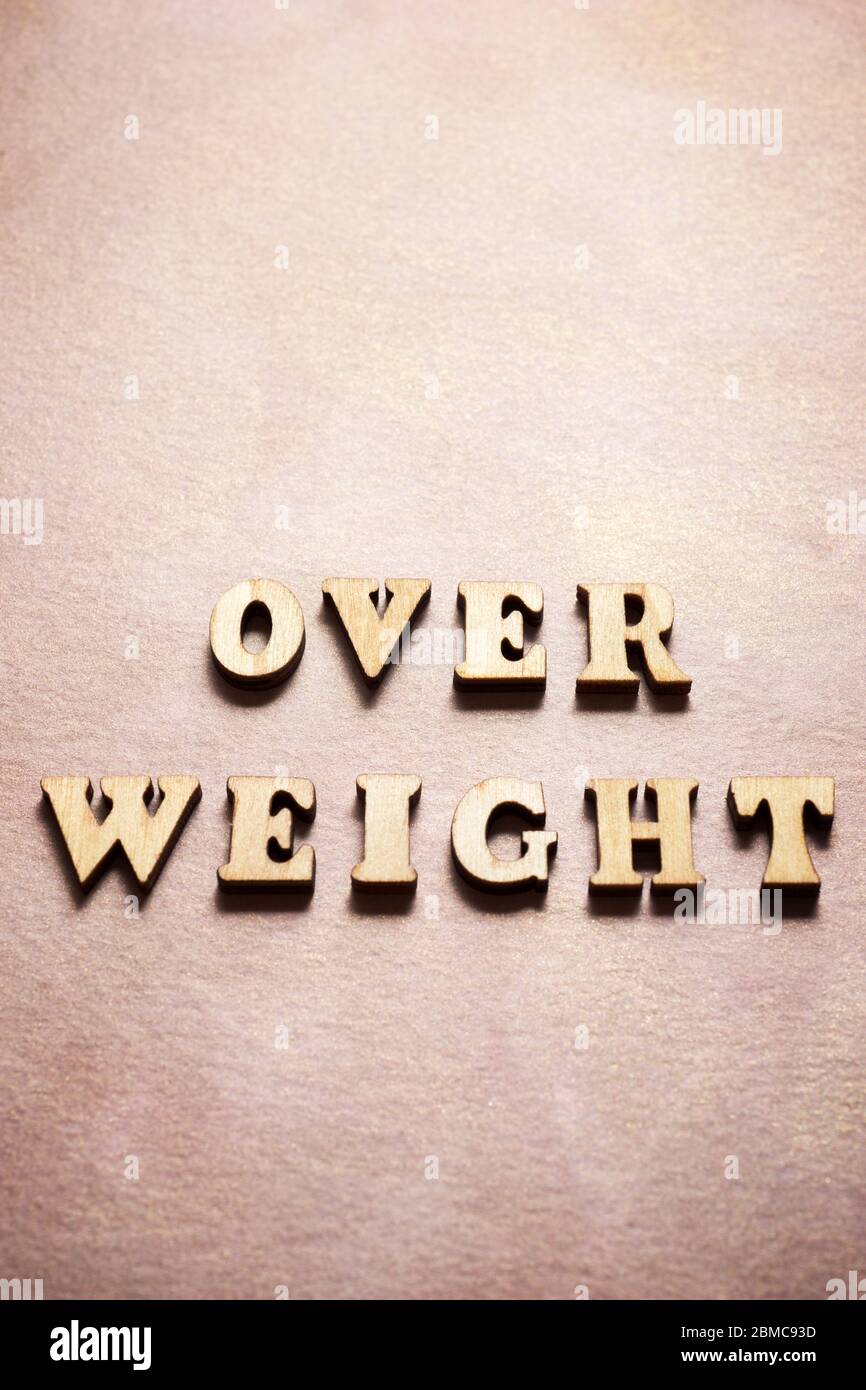 Over weight text on a colored paper. Stock Photo