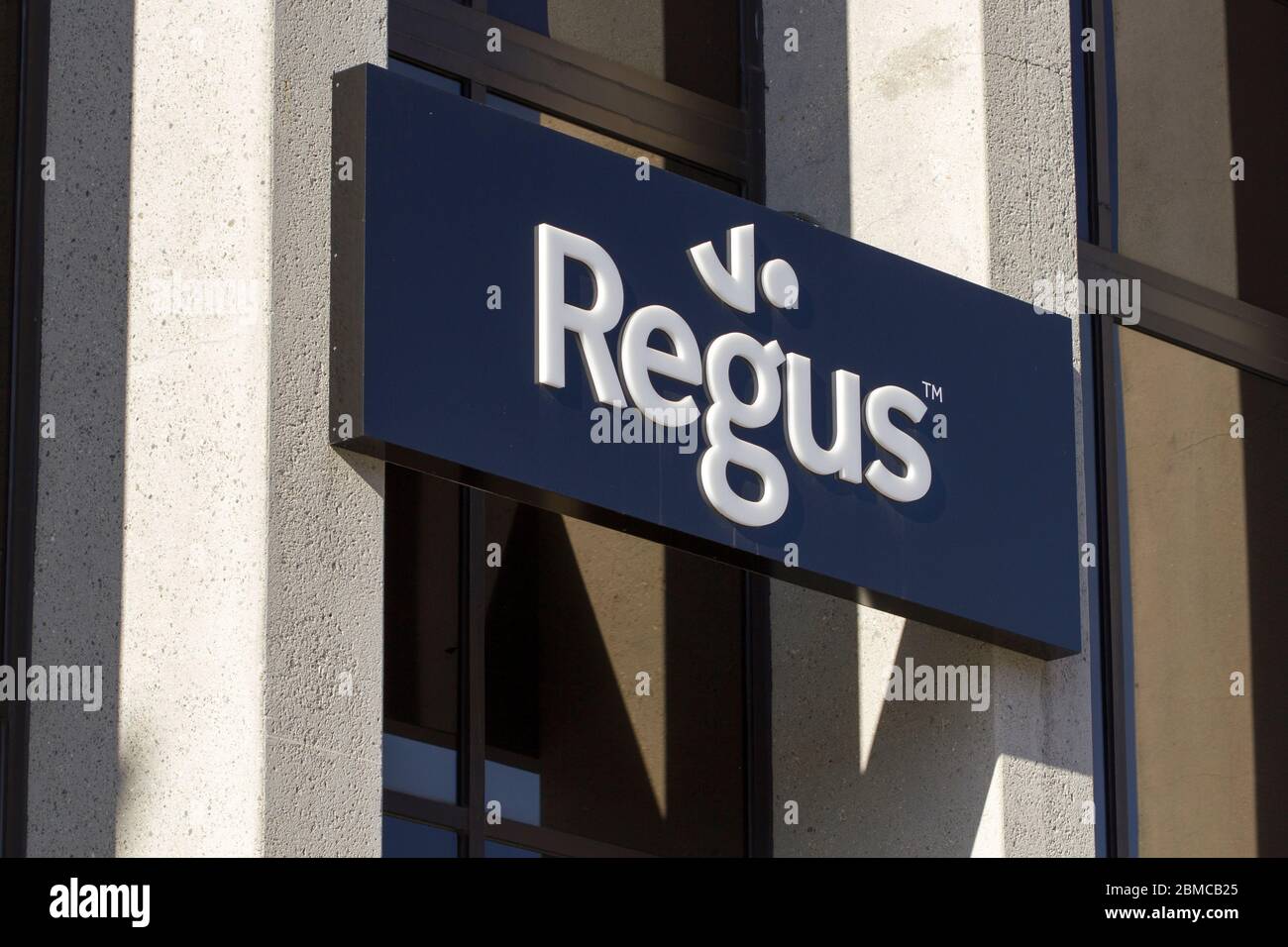 The Regus sign is seen at Regus San Jose location. Regus is a provider of serviced offices, coworking spaces, business lounges, and virtual offices. Stock Photo