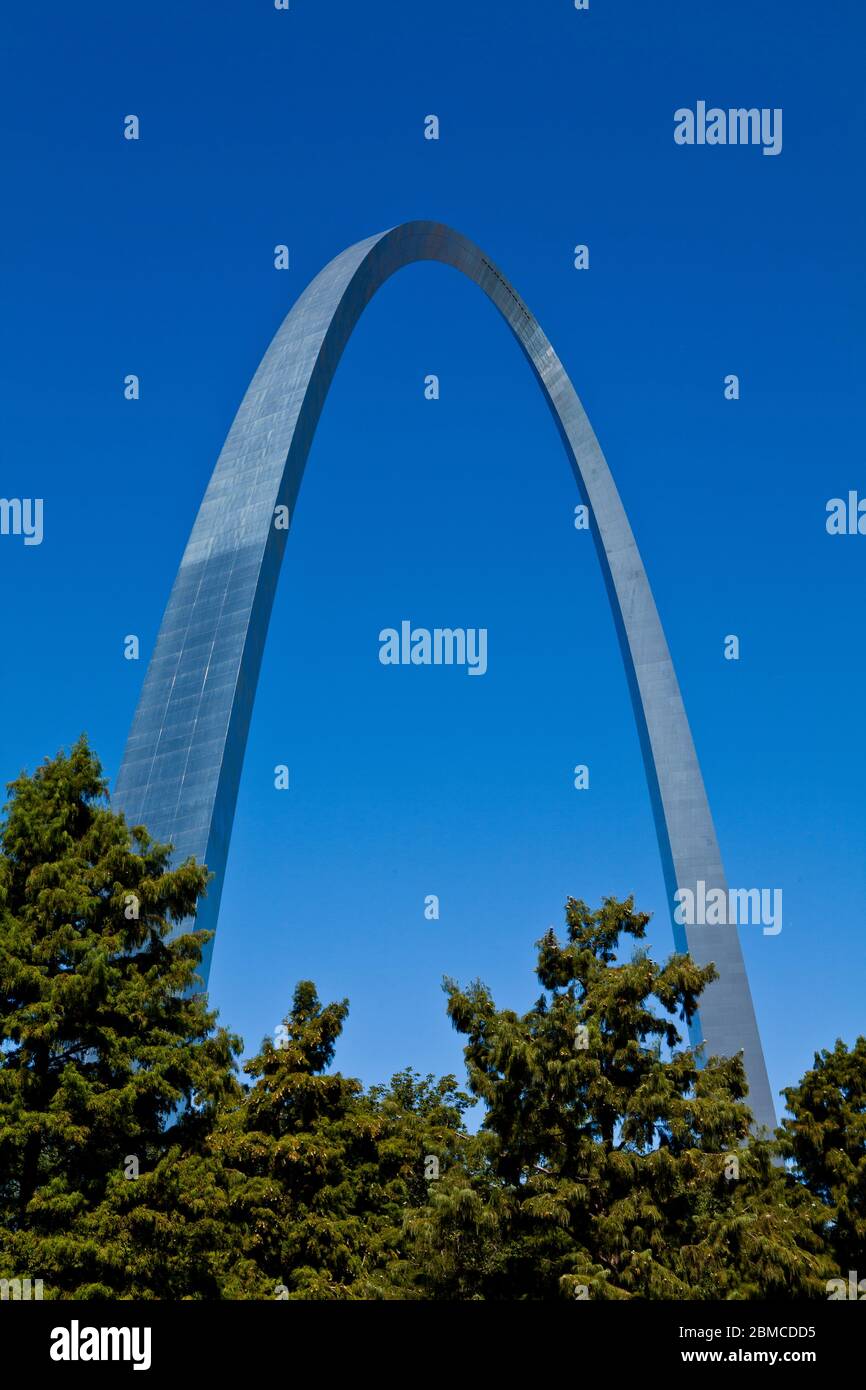 Architect Eero Saarinen's majestic Gateway Arch monument rises above the trees along the Mississippi River in downtown St. Louis, Missouri. Stock Photo