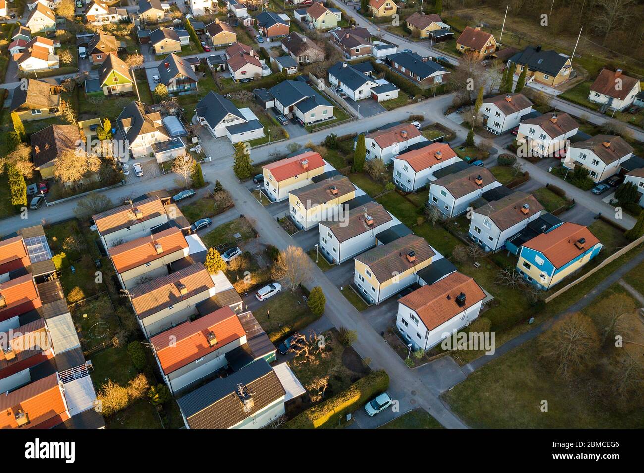 Aerial view of residential houses with red roofs and streets with ...