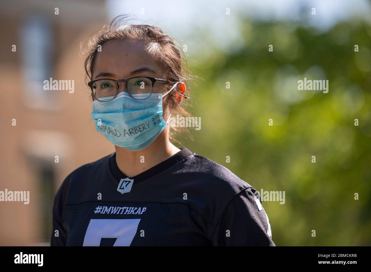 Manhattan, Kansas, USA. 8th May, 2020. FANNY FANG wears a mask with Ahmaud Arbery's name during a 2.23 mile walk in City Park to show support and solidarity for Ahmaud Arbery Tuesday morning. Ahmaud Arbery was wrongfully shot and killed on February, 23, 2020 in Brunswick, Georgia while he was jogging in his neighborhood. Today would have been Arbery's 26th birthday. FANNY FANG organized the walk with her employees at Asian Market-International Grocery and Gifts Credit: Luke Townsend/ZUMA Wire/Alamy Live News Stock Photo