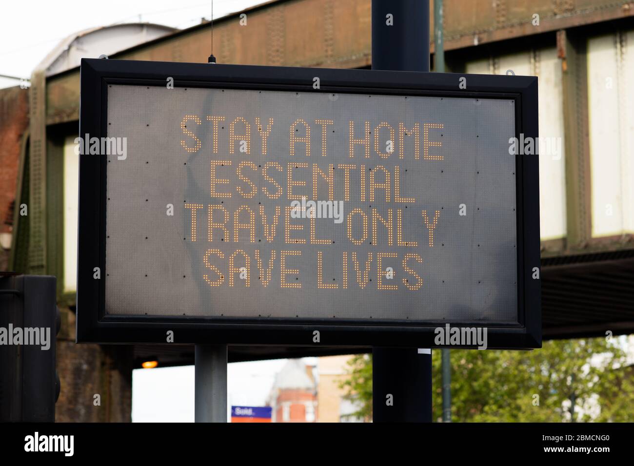 An electronic street sign warns travellers to "stay at home, essential