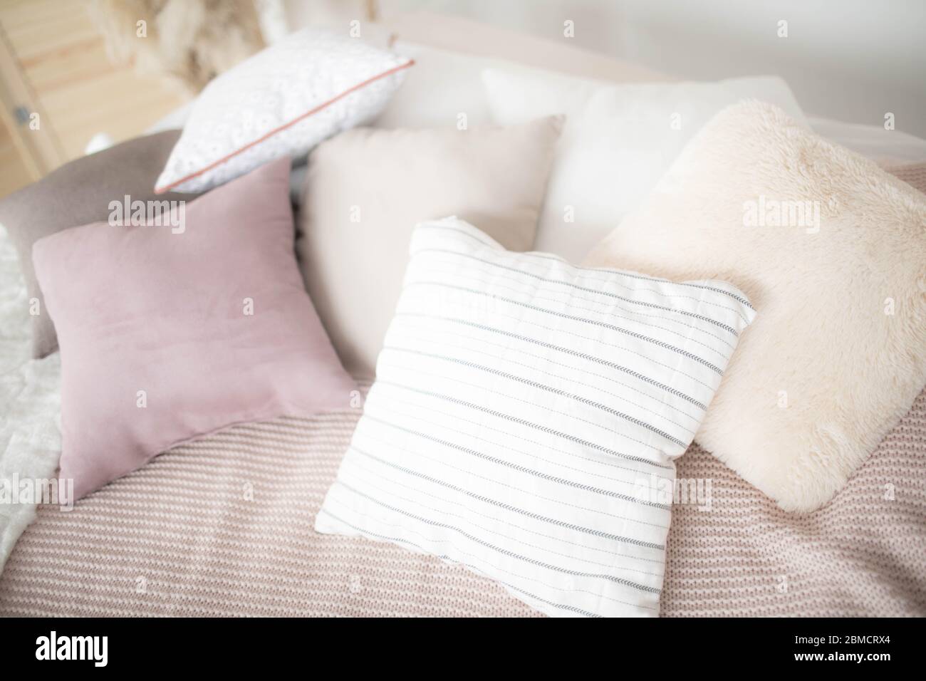 Small square pillows on the sofa. Close up. Stock Photo