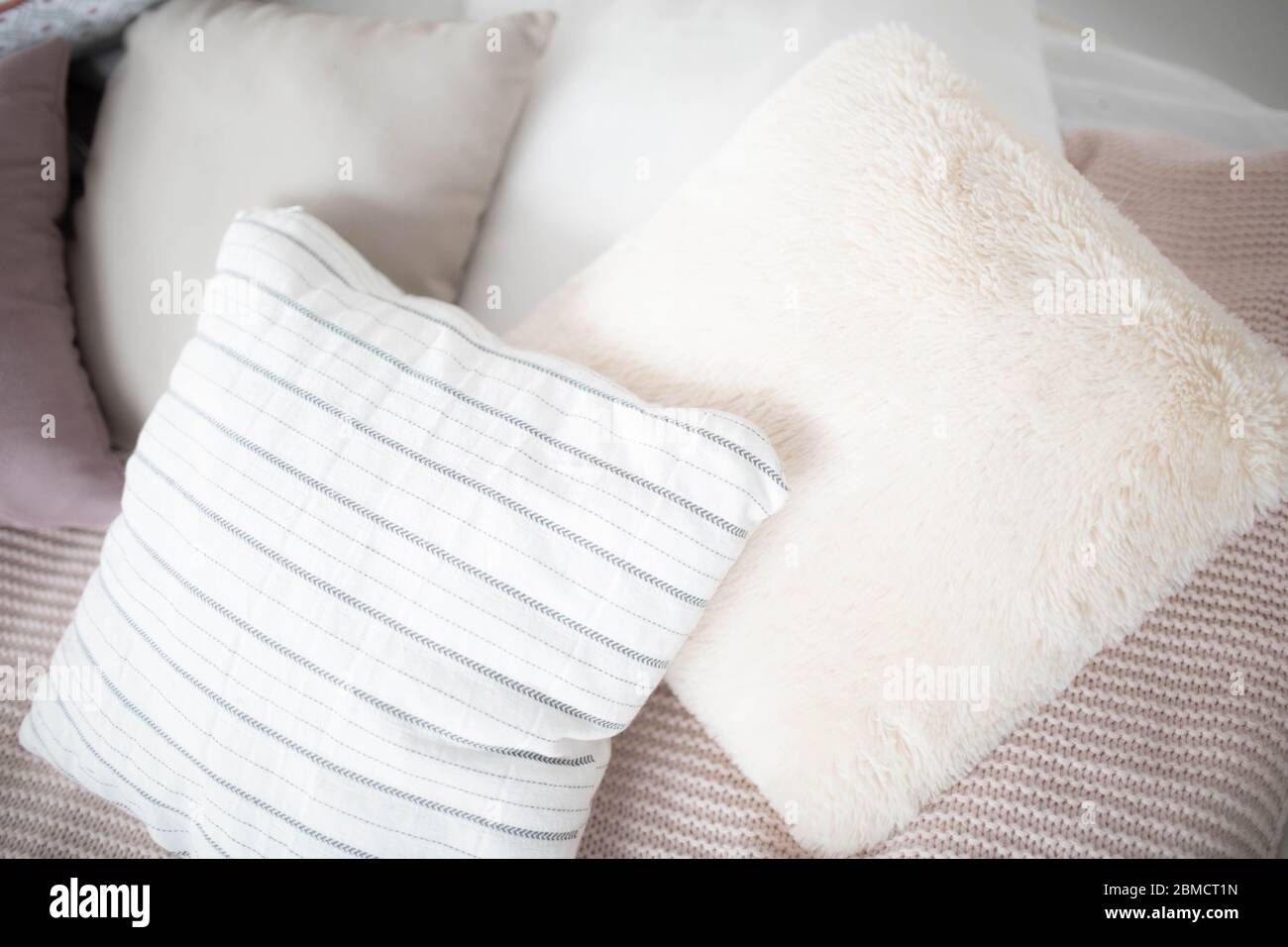 Small square pillows on the sofa. Close up. Stock Photo