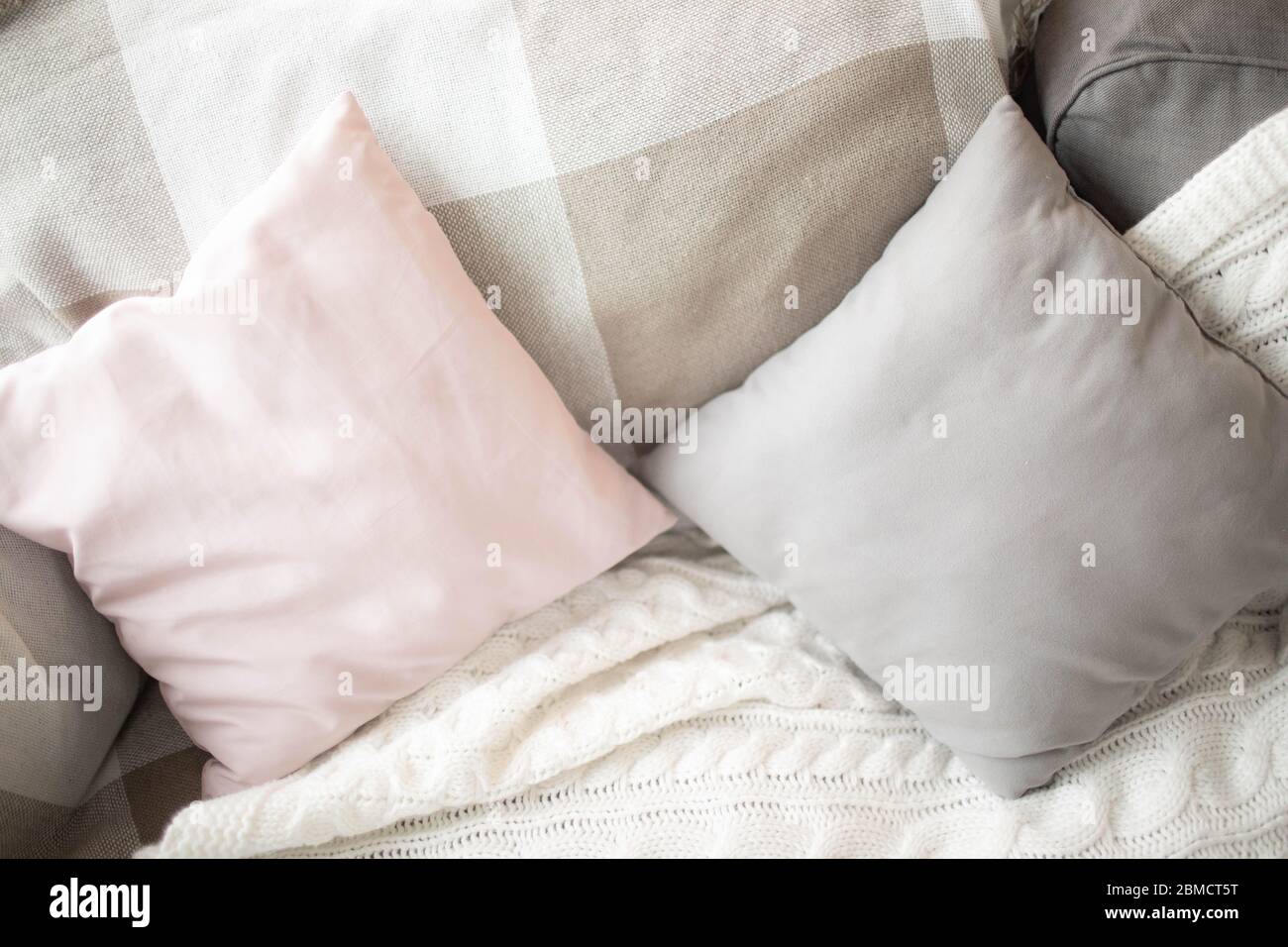 Small square pillows on the sofa. Close up. Stock Photo