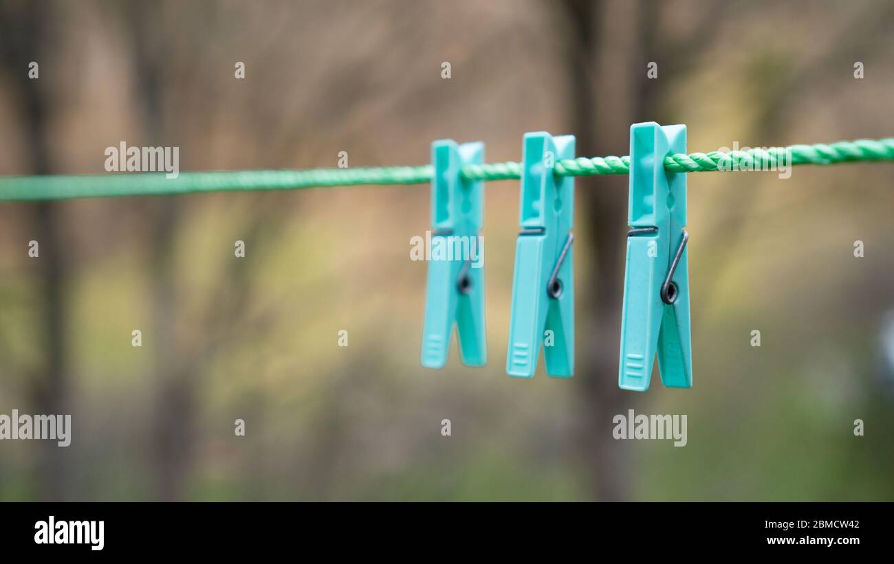 Singlecolored beautiful clothespins hanging on a cord Stock Photo