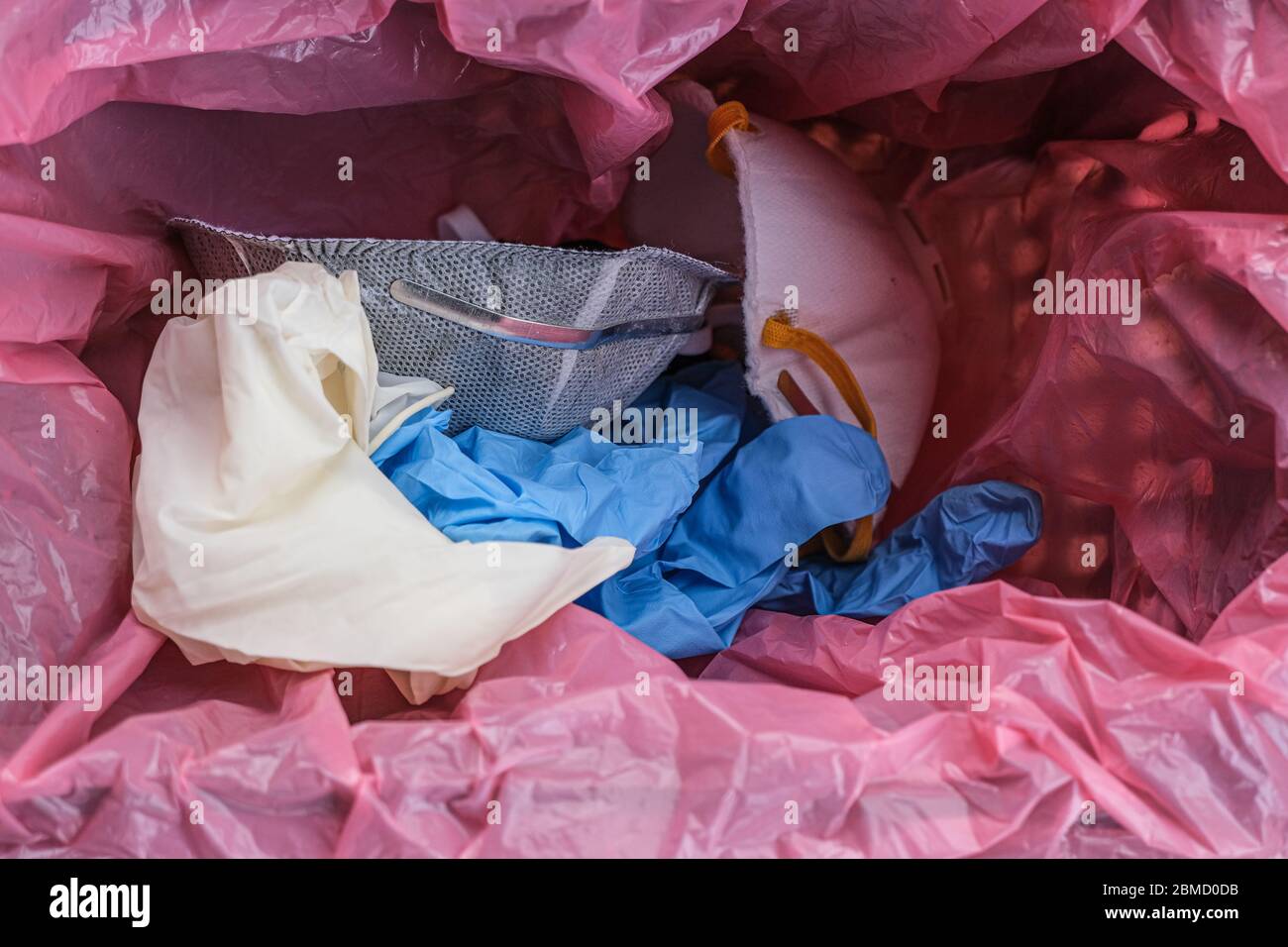 Medical dirty protective mask and gloves in garbage bin,coronavirus disease equipment Stock Photo