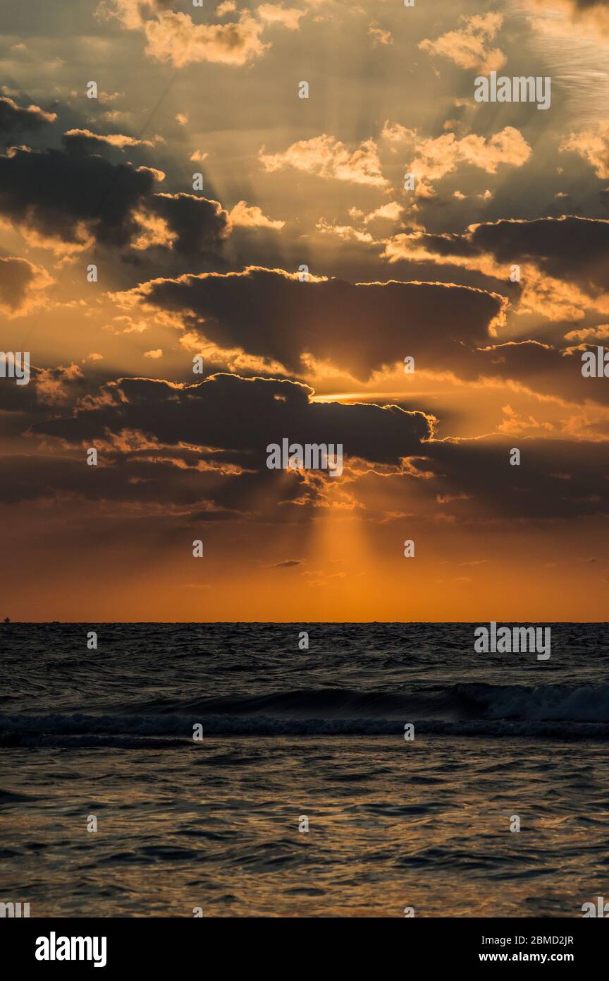 Golden hour of sunset at red sea shore with dramatic sky and the golden ...