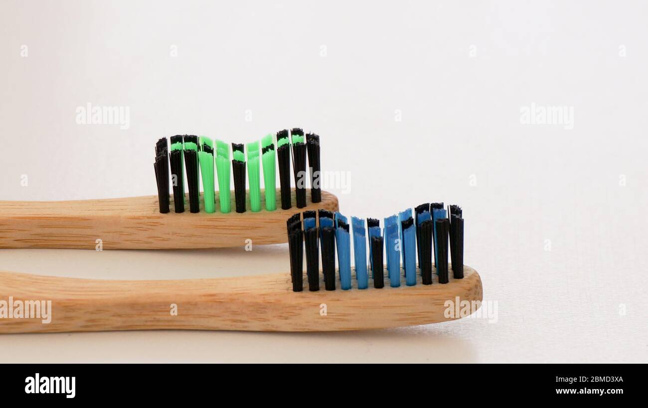 Two bamboo toothbrushes side view white background Stock Photo - Alamy