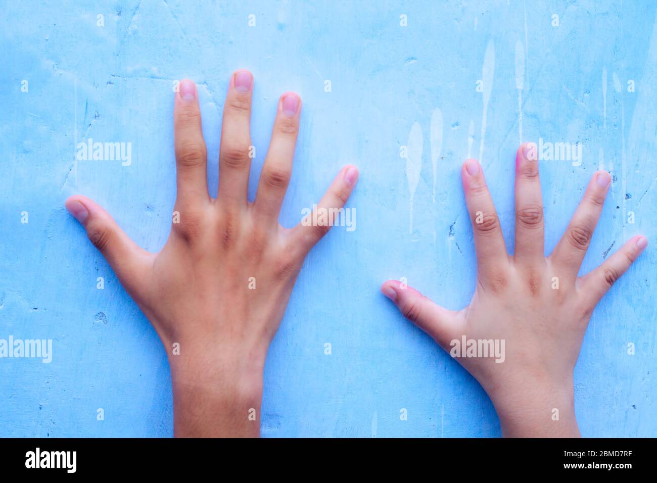 Comparing hands size male female hires stock photography and images