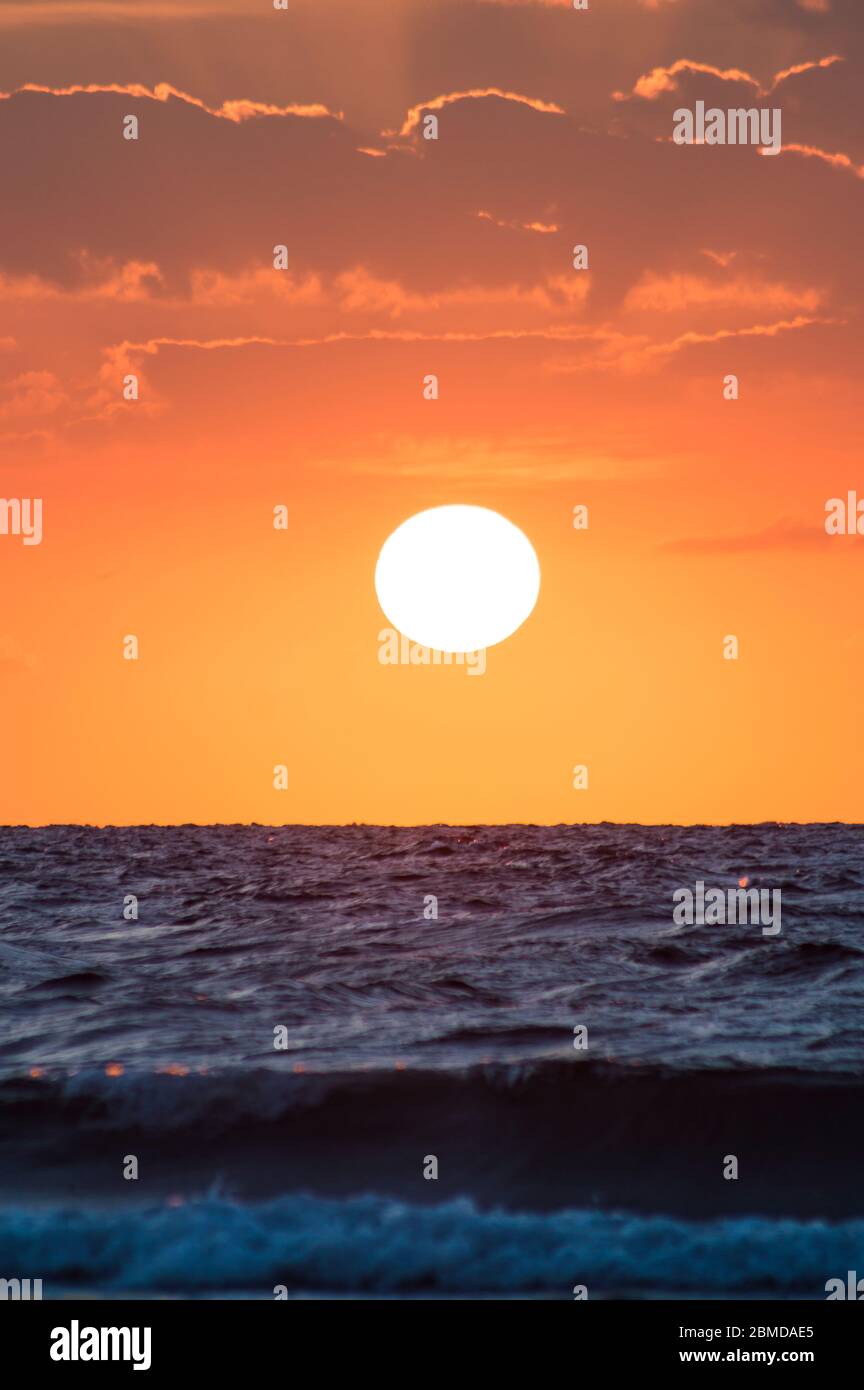 Golden hour of sunset at red sea shore with dramatic sky and the golden ...