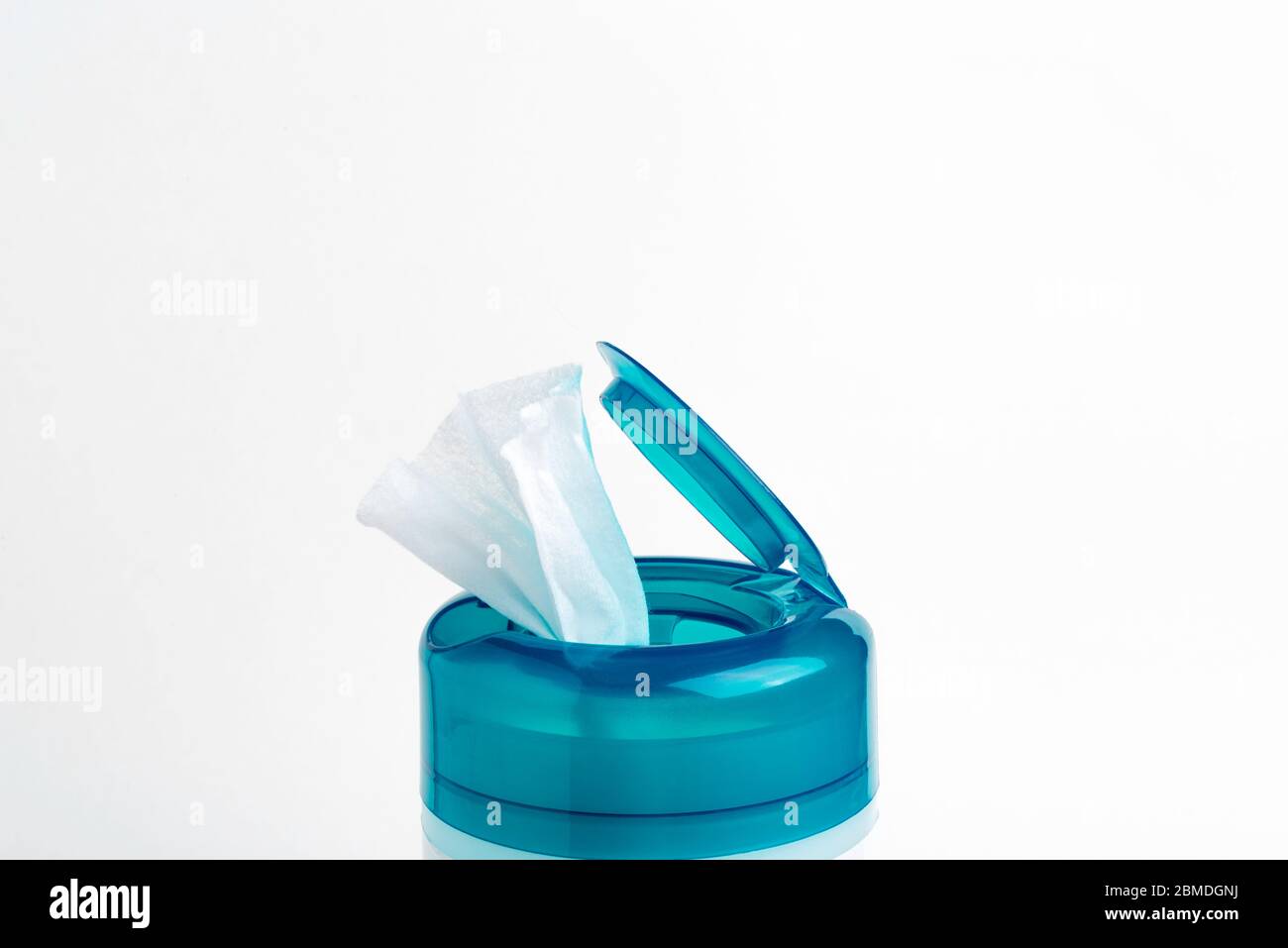A close-up shot of an open aquamarine push top cap of a disinfectant wet wipes plastic container set on a plain white background. Stock Photo