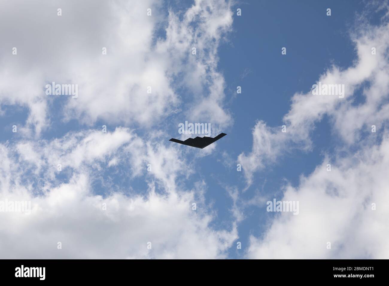 St. Louis, Missouri / USA - May 8th, 2020: B-2 Stealth Bomber Flies though blues sky over St. Louis to salute essential workers. The flyover route started in Camdenton, then Cape Girardeau, St. Louis, Columbia, Jefferson City, and then lastly in Springfield. Stock Photo