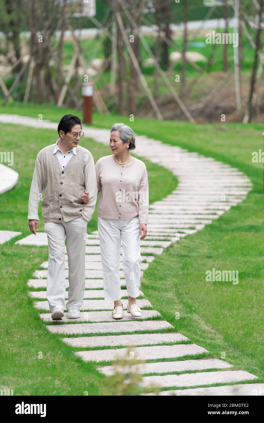 Middle aged asian woman walking hi-res stock photography and images - Alamy