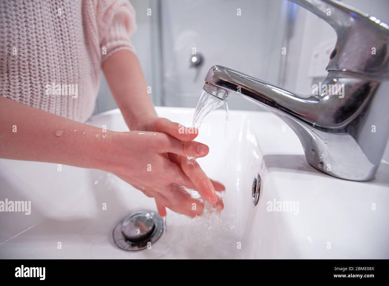 Young girl washing hands in the bathroom - closeup Stock Photo - Alamy