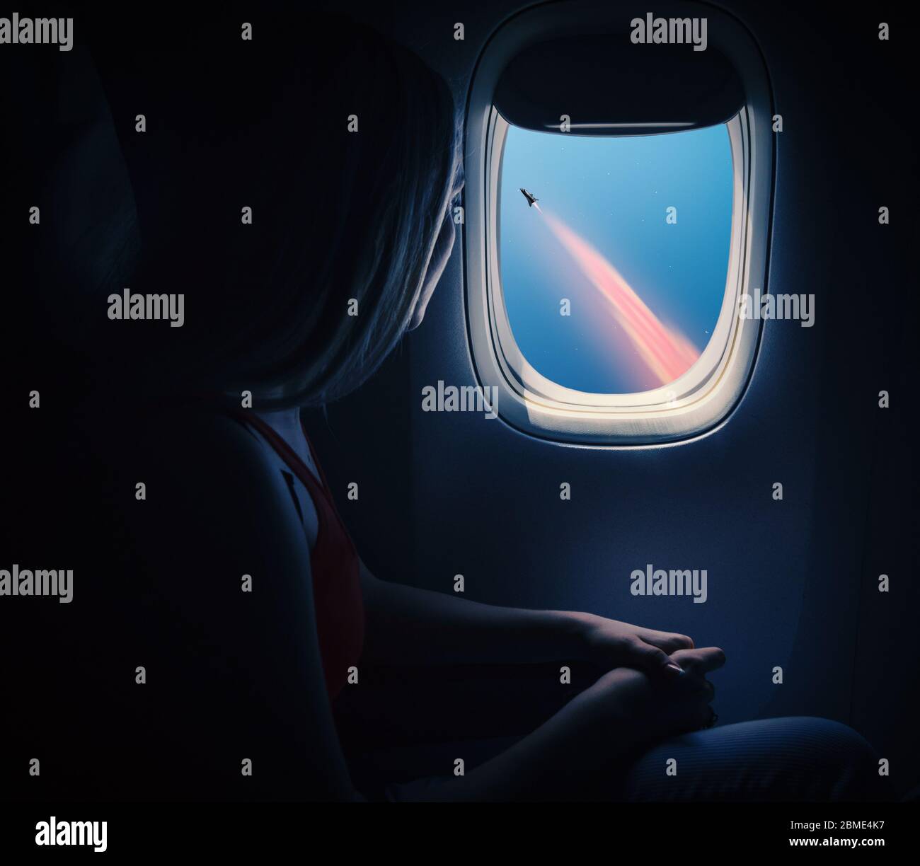 Woman in spaceship looks out the porthole. Commercial space travel concept. Stock Photo
