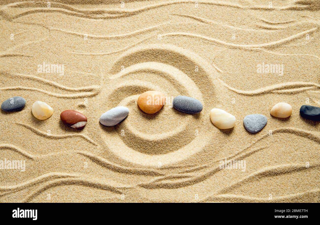 Zen garden with pebbles on sand background Stock Photo