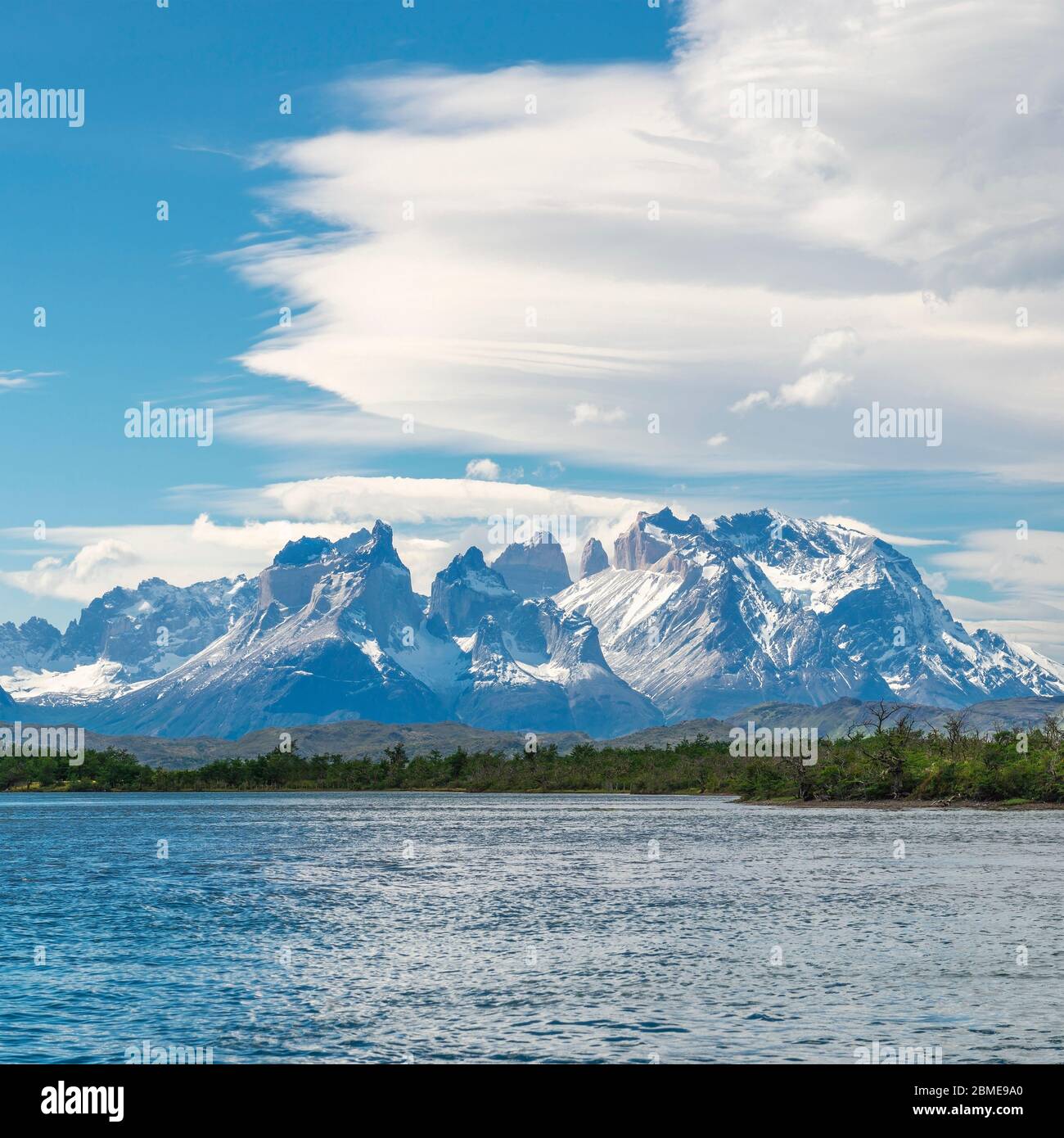 The Torres and Cuernos del Paine peaks seen from the Serrano River with circular clouds, Torres del Paine national park, Patagonia, Chile. Stock Photo