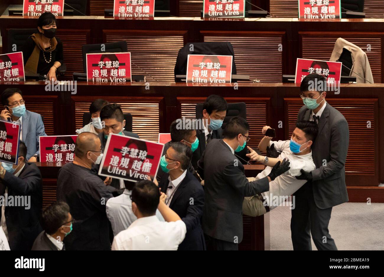 Hong Kong, China. 8th May, 2020. Pro-democracy lawmaker Jeremy Tam (R, Wearing white) is carry away from a House Committee by security guards at the Legislative Council. Several pro-democracy legislators were dragged out of the chamber by security guards as the pro-democracy and the pro-Beijing camps scuffled for control of the House Committee which has been gridlocked for months. The House Committee is responsible for scrutinising bills before sending them for a final vote. Credit: May James/ZUMA Wire/Alamy Live News Stock Photo
