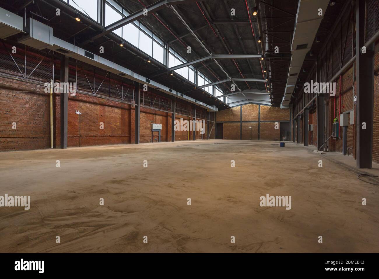 Unmanned, industrial style old warehouse building space. Stock Photo