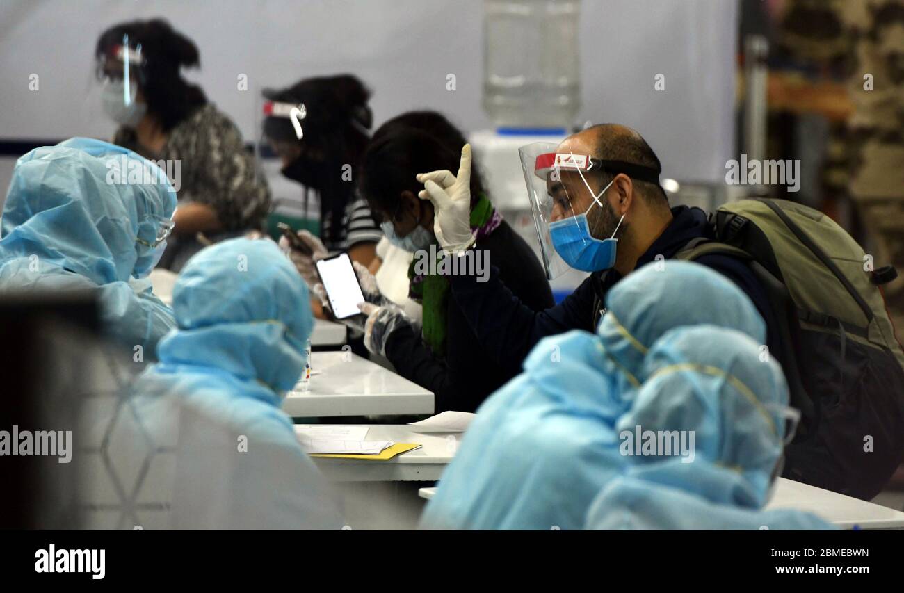 India, India. 8th May, 2020. Medics screen stranded Indians arriving from Singapore at an airport in New Delhi, India, on May 8, 2020. The flights bringing back stranded Indians from abroad have begun to arrive in India, officials said Friday. Credit: Partha Sarkar/Xinhua/Alamy Live News Stock Photo