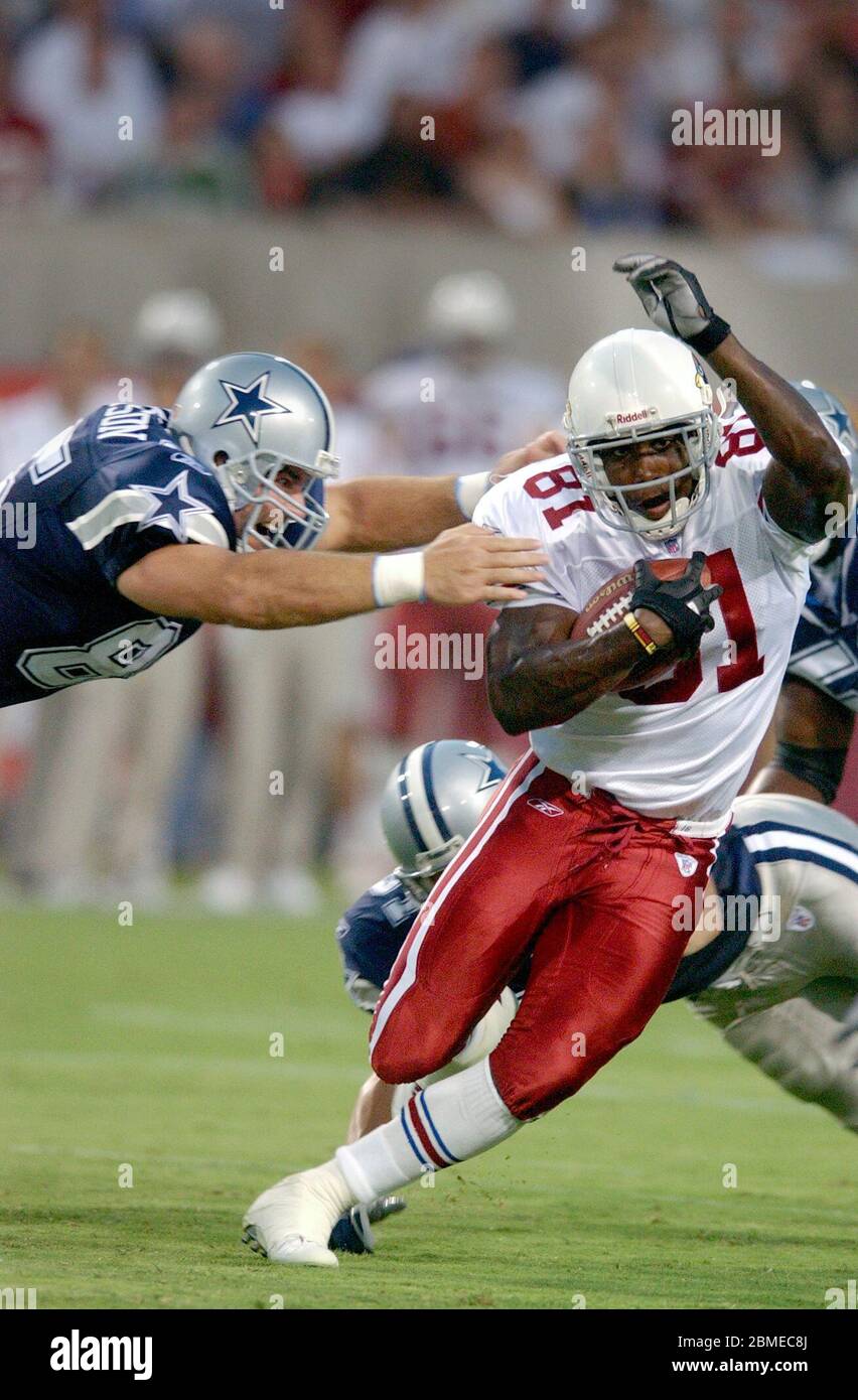 Tempe, United States. 09th Aug, 2003. Arizona Cardinals rookie wide  receiver Anquan Boldin tries to elude a diving Jeff Robinson of the Dallas  Cowboys.The Cardinals defeated the Cowboys, 13-0, during an NFL