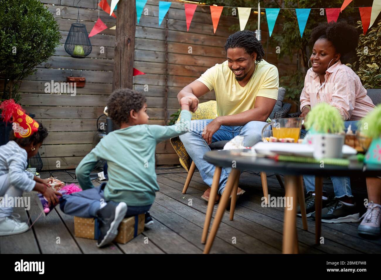 young afro-american family gathered in the backyard during quarantine Stock Photo
